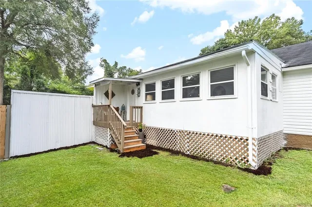 a house with huge green field and large trees