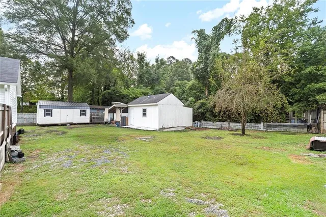 a view of a house with a yard and sitting area