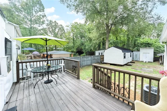 a patio with a table and chairs under an umbrella
