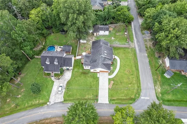 an aerial view of a house with a garden and swimming pool