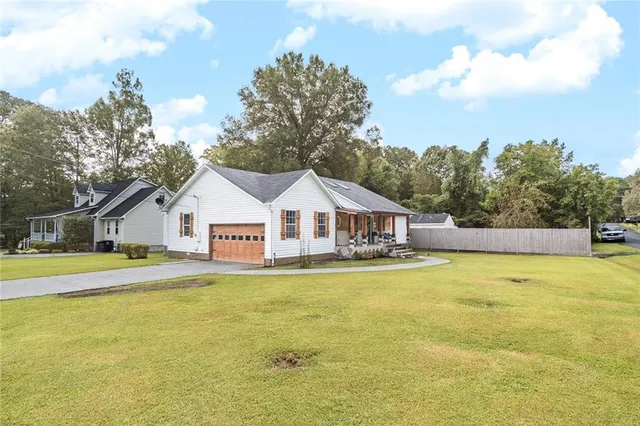 a view of a house with a yard and swimming pool