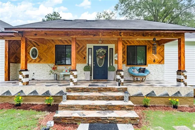 a front view of a house with outdoor seating