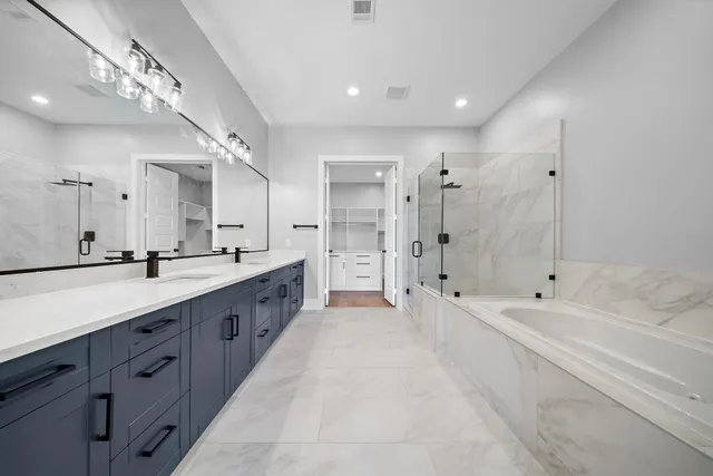 a large bathroom with a double vanity sink mirror double and shower