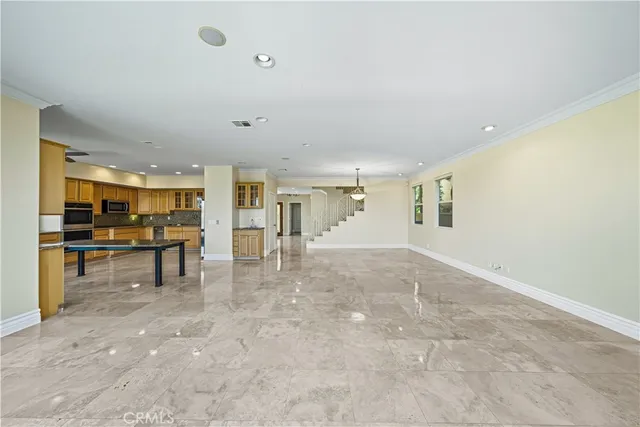 a view of an empty room with a fireplace and a window