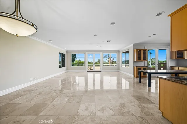an empty room with windows and ceiling fan