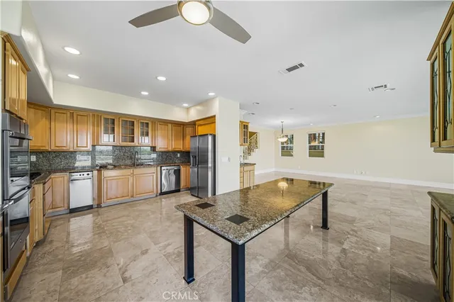 a kitchen with stainless steel appliances granite countertop a refrigerator and cabinets