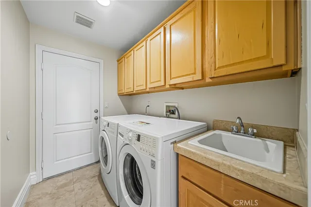 a kitchen with stainless steel appliances kitchen island granite countertop a refrigerator and cabinets