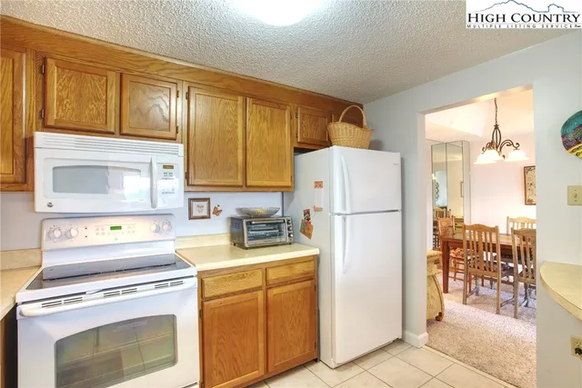 a kitchen with a stove a refrigerator and a sink