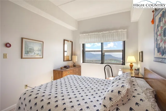 a bedroom with a large bed and a large window