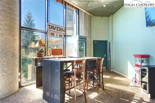 a living room with furniture a fireplace and a large window