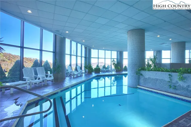 a view of a kitchen with kitchen island stainless steel appliances a counter space and a view of living room