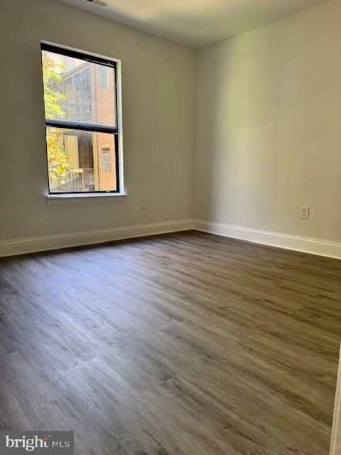106 Mountain Road, Unit 2C Pasadena, MD 21122 - Photo 15 of 17 a view of an empty room with wooden floor and a window