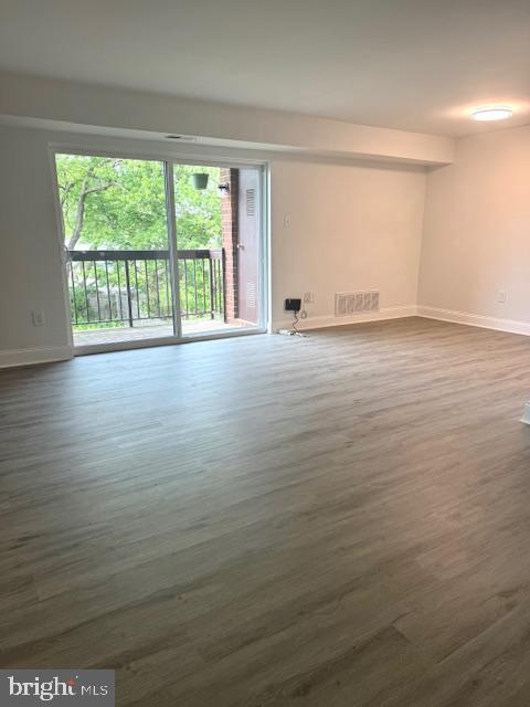 106 Mountain Road, Unit 2C Pasadena, MD 21122 - Photo 3 of 17 wooden floor in an empty room with a window