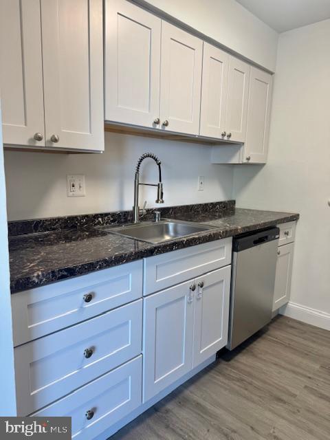 106 Mountain Road, Unit 2C Pasadena, MD 21122 - Photo 8 of 17 a kitchen with granite countertop white cabinets and a sink