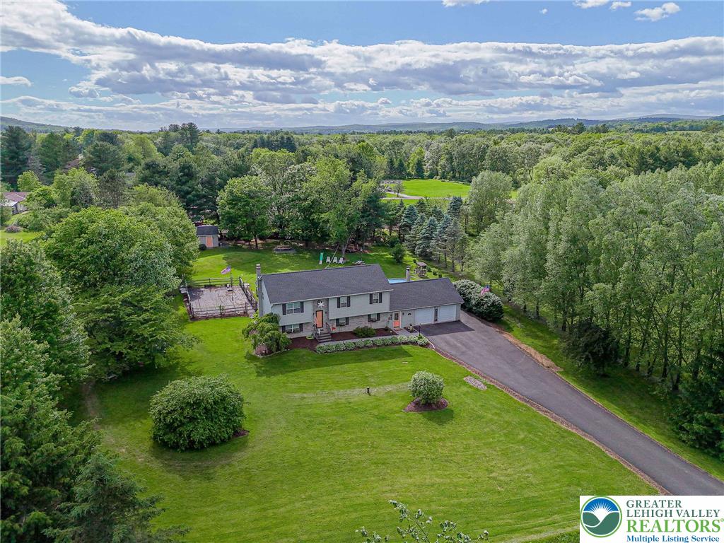 341 Lower Greenhill Road Kunkletown, PA 18058 - Photo 4 of 69 An aerial perspective reveals a charming residence nestled amidst a verdant landscape, offering expansive outdoor leisure.
