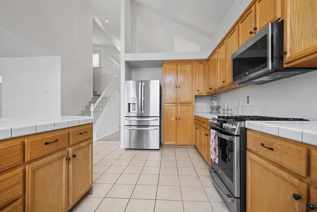 a kitchen with a sink a counter top space and appliances