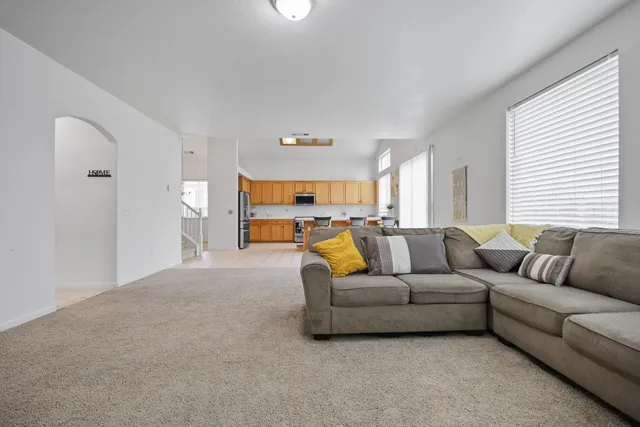a spacious bedroom with a bed and a chandelier