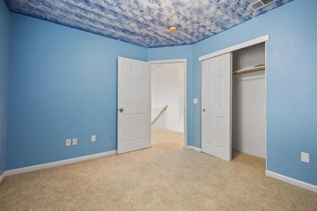 a view of a white house next to yard