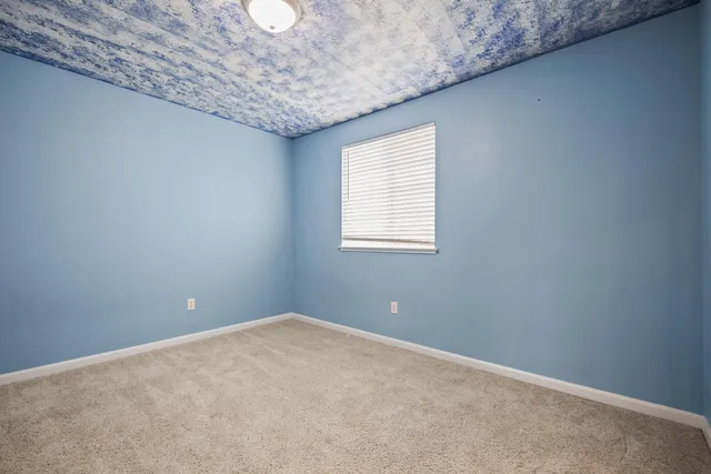 a view of a house with a backyard and a patio