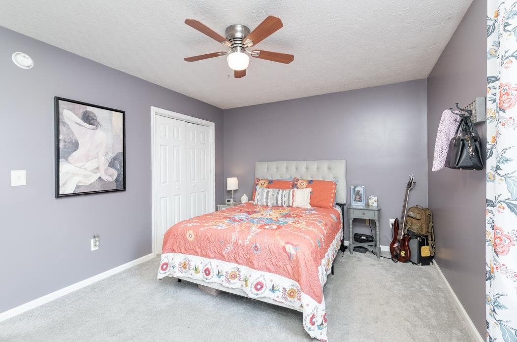 138 Buckboard Road Waynesboro, VA 22980 - Photo 21 of 54 a bedroom with a bed and a chandelier