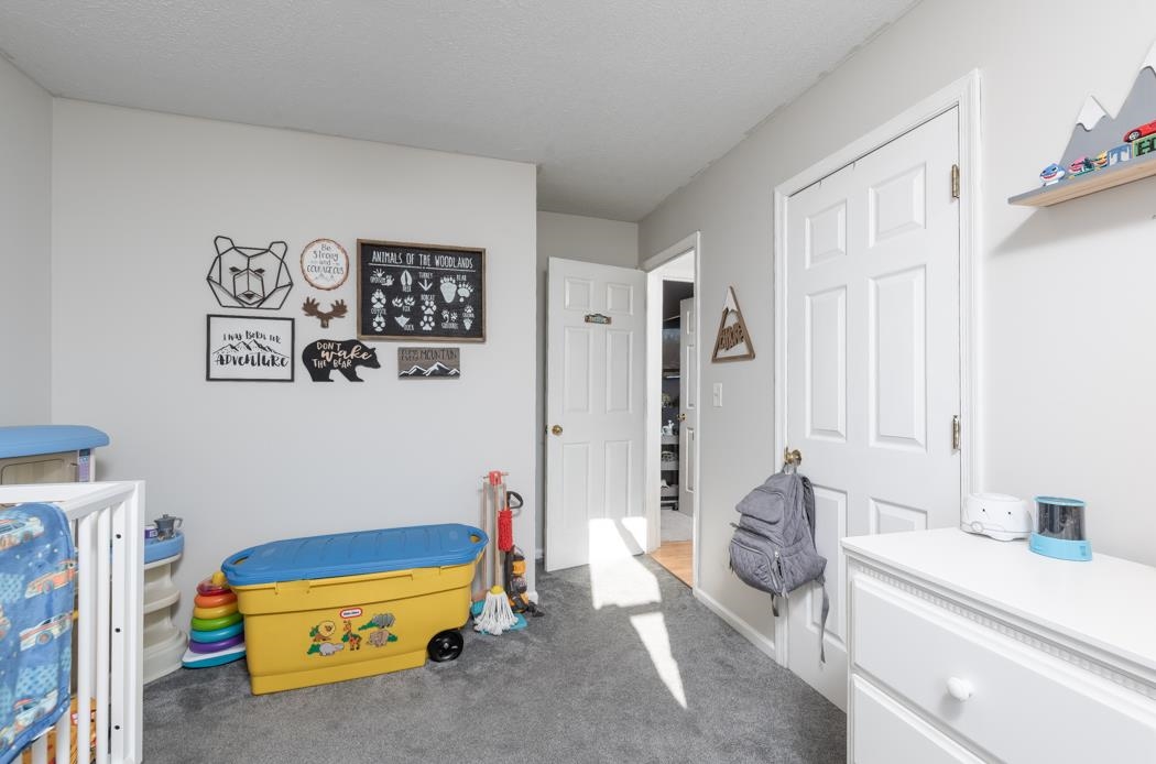 138 Buckboard Road Waynesboro, VA 22980 - Photo 31 of 54 a room with a baby bed a couch and a window