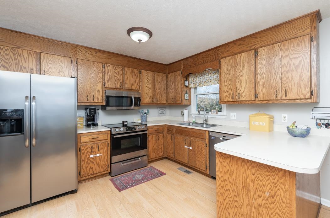 138 Buckboard Road Waynesboro, VA 22980 - Photo 10 of 54 a kitchen with stainless steel appliances granite countertop a refrigerator stove top oven a sink and dishwasher