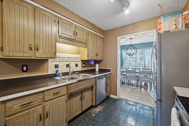 a kitchen with stainless steel appliances granite countertop a sink stove and cabinets