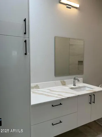 a bathroom with a sink and mirror