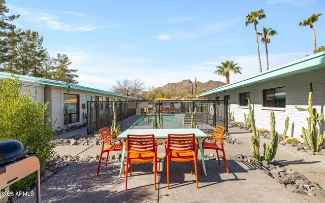 a view of a house with backyard and sitting area