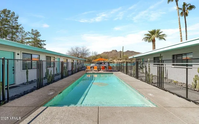 a front view of a house with basket ball court and potted plants