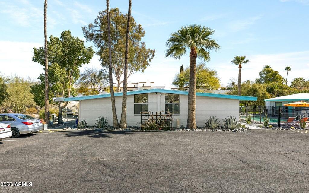 7440 East Cave Creek Road, Unit 6 Carefree, AZ 85377 - Photo 29 of 46 a front view of a house with basket ball court and potted plants
