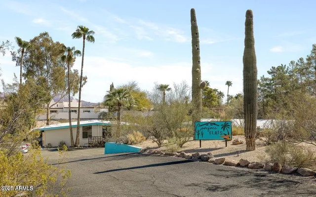 an aerial view of a house with outdoor space and swimming pool
