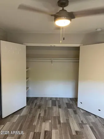a view of a room with wooden floor and chandelier