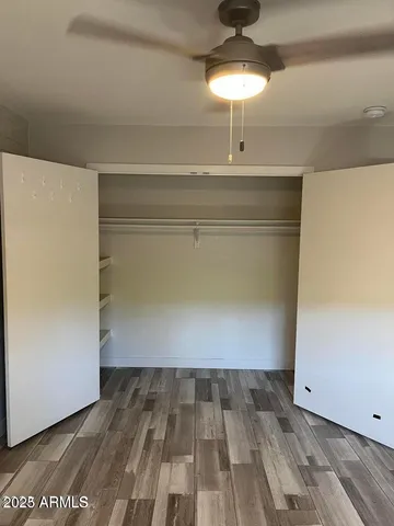 a view of a room with wooden floor and chandelier