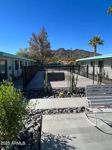 a view of a patio with table and chairs under an umbrella