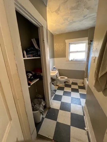 a view of a house with a black and white checkered floor