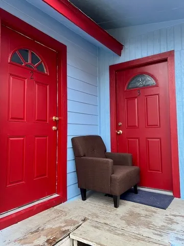 a living room with furniture and a wooden door