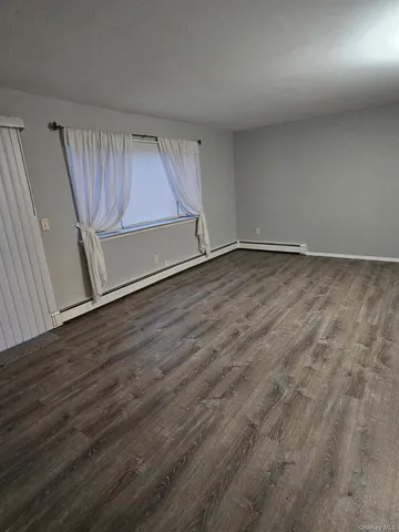 a bathroom with a granite countertop sink mirror vanity and toilet