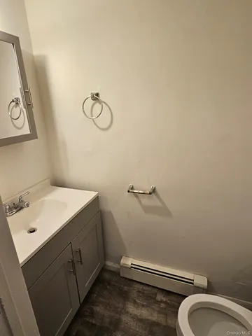 a kitchen with stainless steel appliances granite countertop white cabinets a sink a stove a microwave and a refrigerator