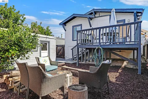 a view of a patio with couches table and chairs and potted plants
