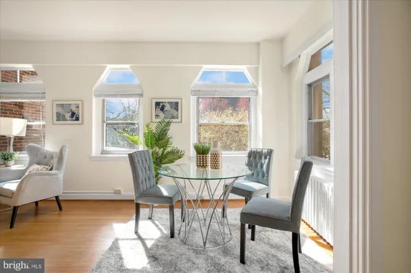 a view of a dining room with furniture and a window