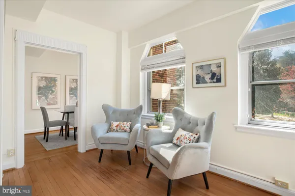 a living room with furniture wooden floor and a window
