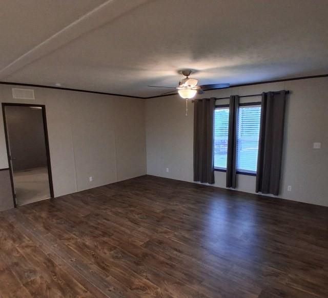798 North 4190 Road Hugo, OK 74743 - Photo 8 of 16 an empty room with wooden floor and windows