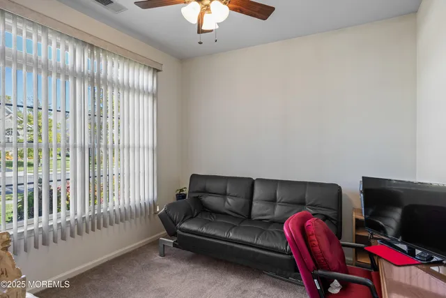 a bedroom with a large bed and a tv