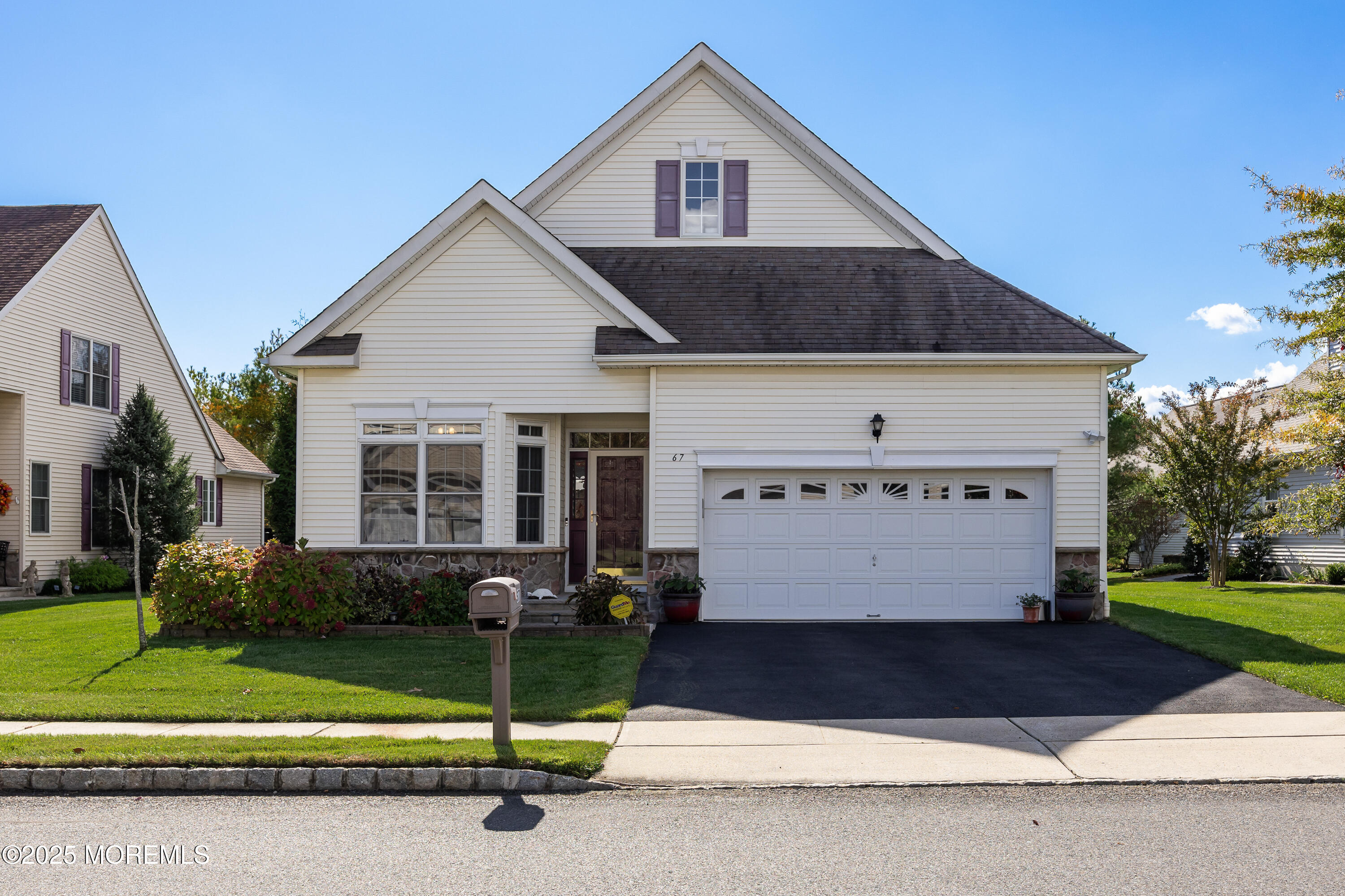 67 Sequoia Parkway Asbury Park, NJ 07712 - Photo 2 of 38 a front view of a house with a garden and plants