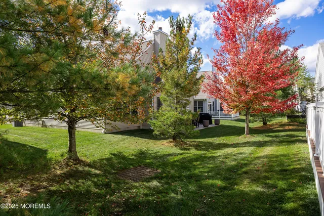 a front view of a house with a yard and road