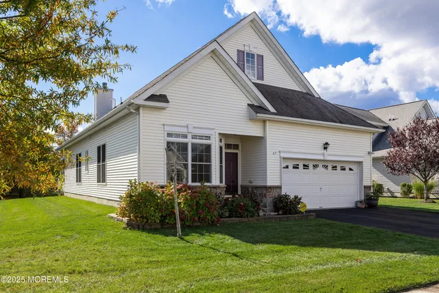a front view of a house with a garden