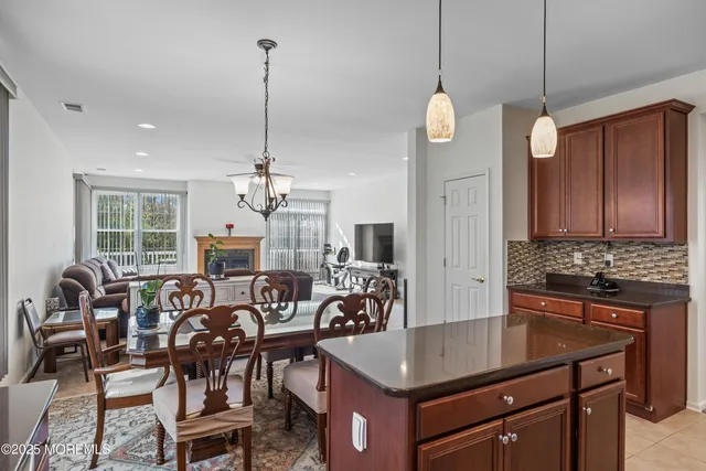 a kitchen with stainless steel appliances granite countertop a sink a stove and a refrigerator