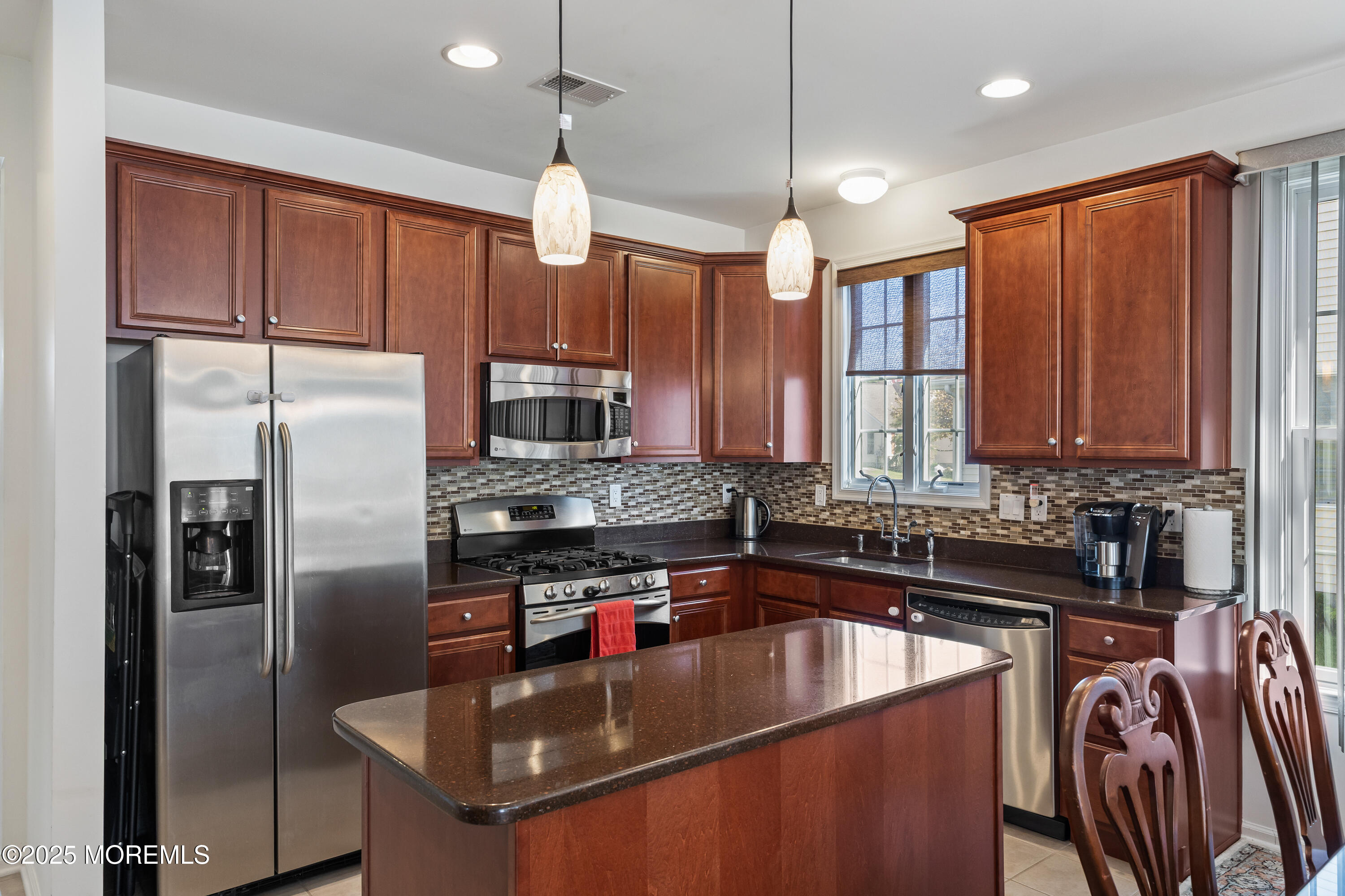 67 Sequoia Parkway Asbury Park, NJ 07712 - Photo 9 of 38 a kitchen with stainless steel appliances granite countertop a sink a stove and a refrigerator