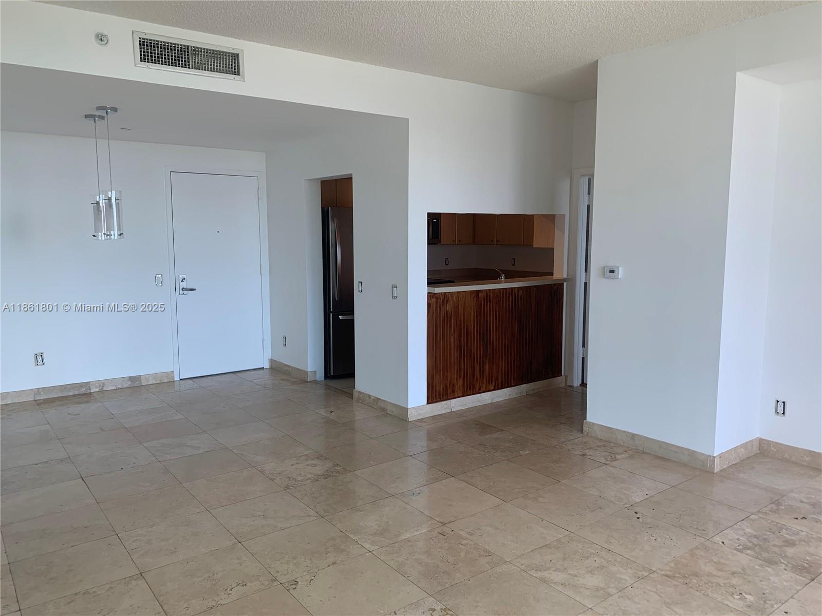 2475 Brickell Avenue, Unit 2504 Miami, FL 33129 - Photo 25 of 32 a view of kitchen with refrigerator and microwave